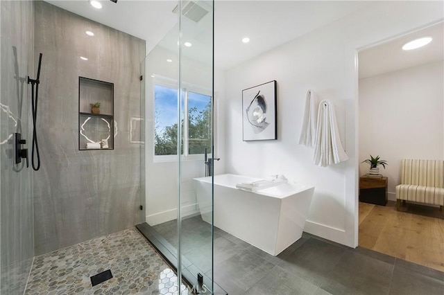 bathroom with tile patterned floors and independent shower and bath