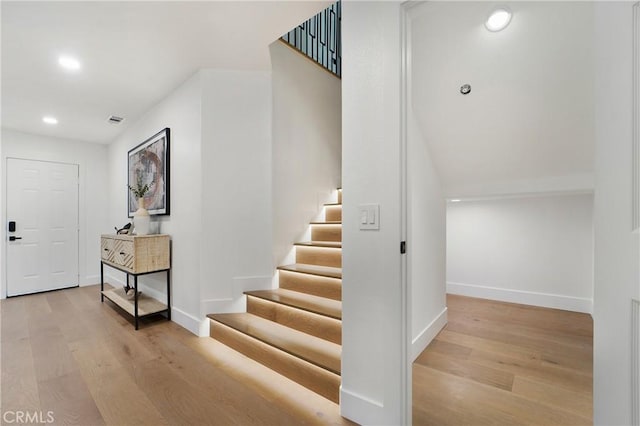 stairs featuring wood-type flooring