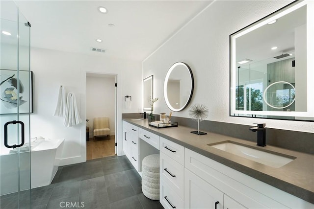 bathroom with walk in shower, tile patterned floors, and vanity