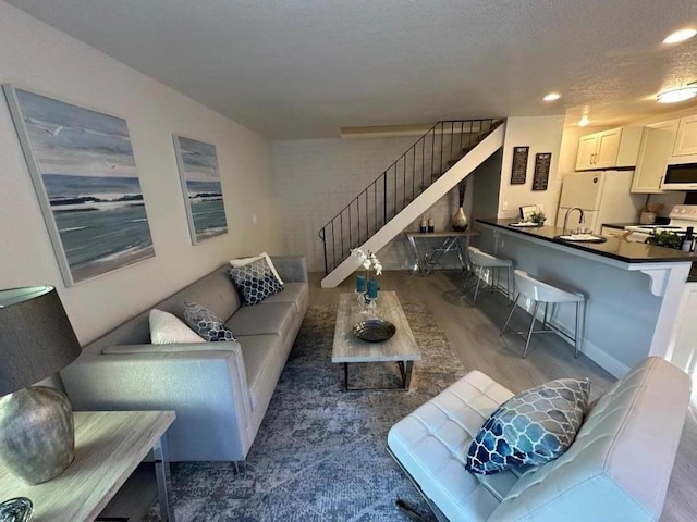 living room featuring hardwood / wood-style flooring and a textured ceiling