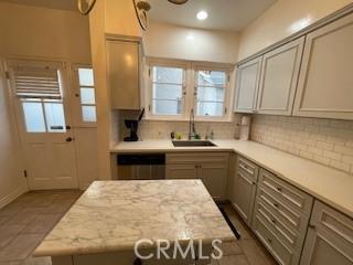 kitchen with dishwasher, plenty of natural light, sink, and decorative backsplash