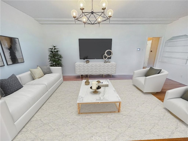 living room featuring an inviting chandelier and wood-type flooring