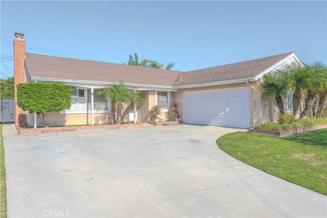 ranch-style house featuring a garage and a front yard