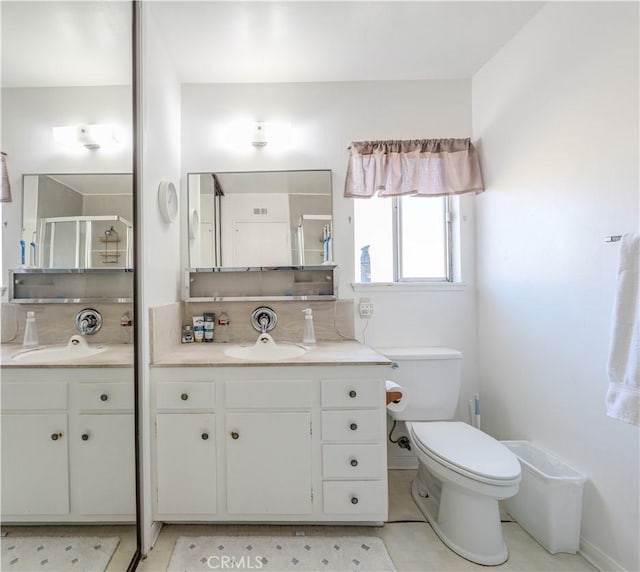 bathroom with vanity, toilet, an enclosed shower, and backsplash