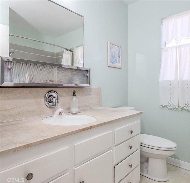 bathroom with vanity, a shower with shower curtain, and toilet