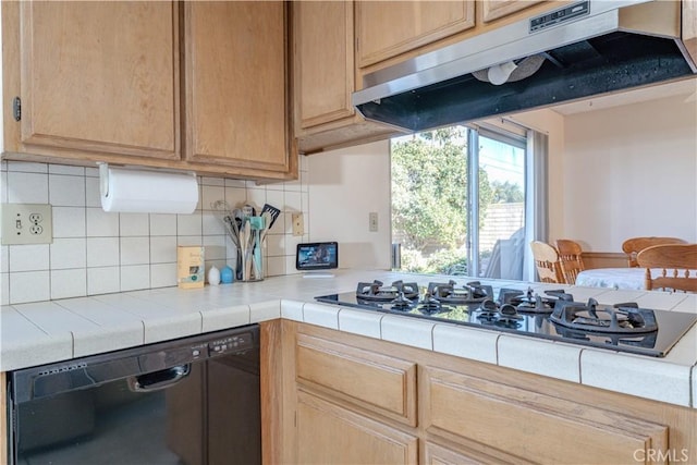 kitchen with tasteful backsplash, tile counters, black dishwasher, and stainless steel gas cooktop