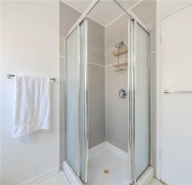 bathroom featuring a shower with shower door