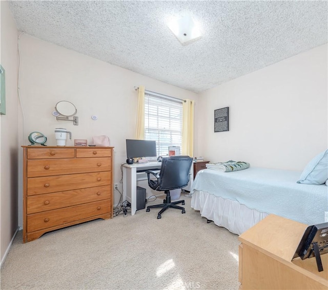 carpeted bedroom featuring a textured ceiling