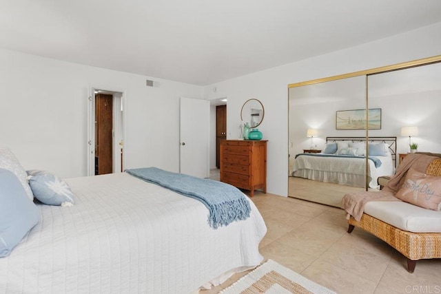 bedroom with a closet and light tile patterned flooring