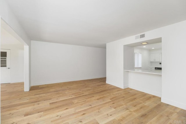 unfurnished living room featuring light wood-type flooring