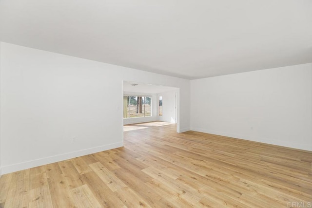 unfurnished room with light wood-type flooring