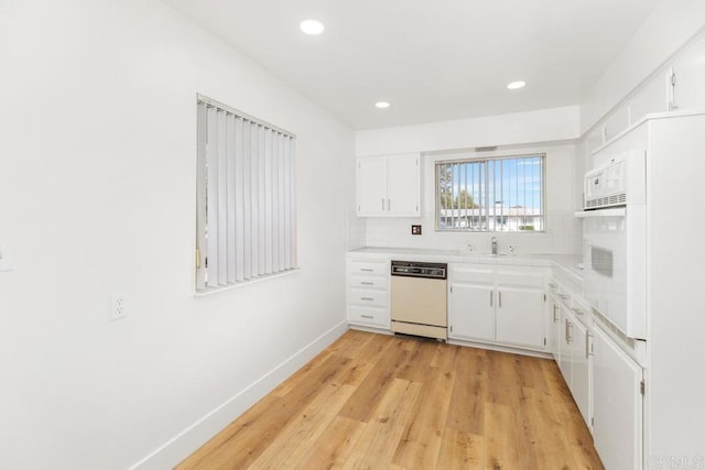 26405 Cherry Hills Blvd, Menifee, CA 92586 - kitchen with white appliances, tasteful backsplash, light countertops, light wood-style floors, and white cabinetry