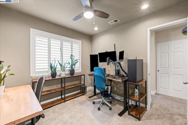 carpeted home office featuring ceiling fan