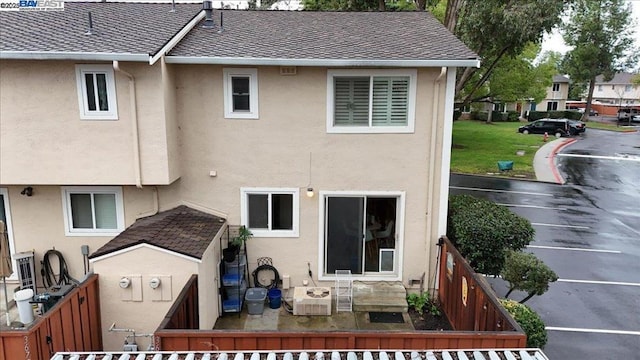 back of house with central AC unit