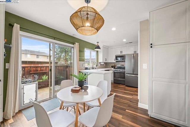 dining room featuring dark wood-type flooring and sink