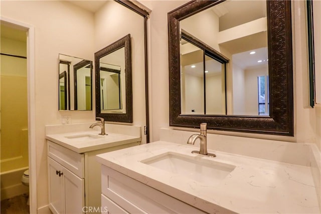 bathroom featuring vanity, a shower, and toilet