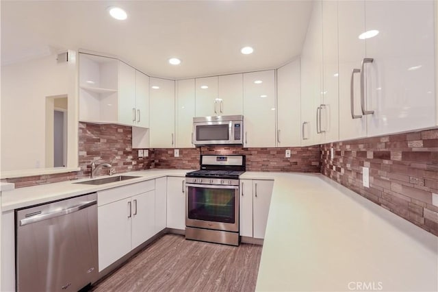 kitchen with sink, stainless steel appliances, and white cabinets