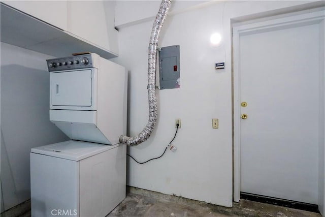 laundry room featuring stacked washer and dryer and electric panel