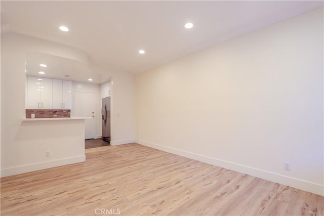 unfurnished living room with light hardwood / wood-style floors