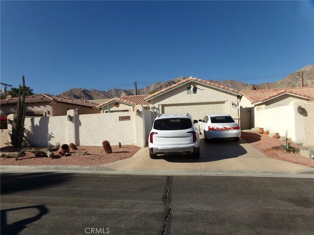 view of front of home with a mountain view and a garage