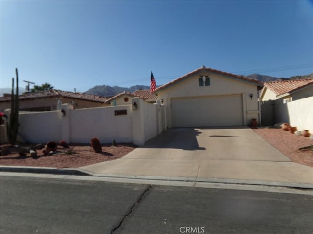 view of front of home featuring a garage and a mountain view