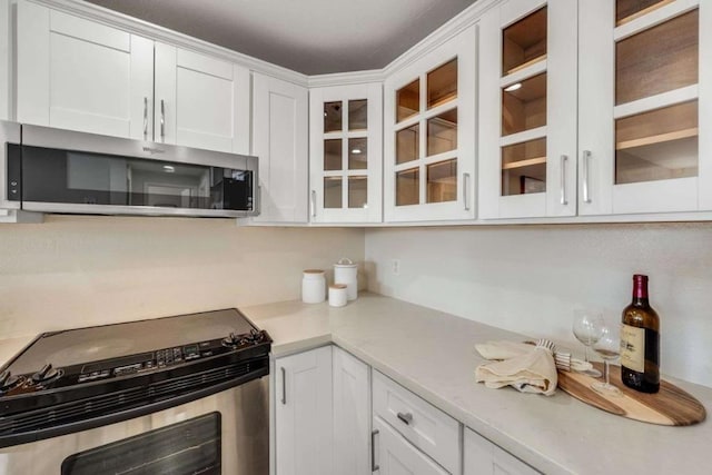 kitchen with white cabinets and appliances with stainless steel finishes