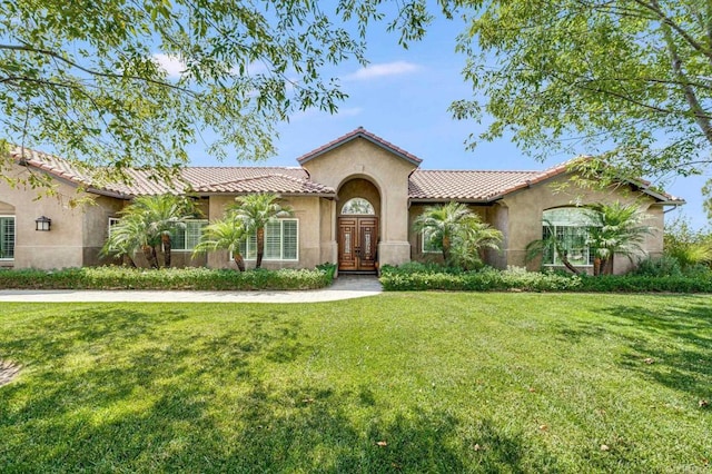 mediterranean / spanish-style home with a front yard