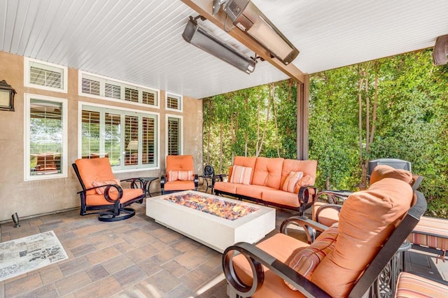 view of patio with an outdoor living space with a fire pit