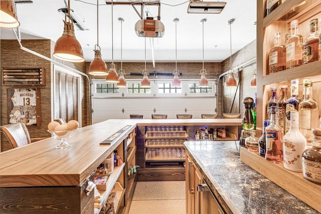 kitchen featuring decorative light fixtures, a center island, and butcher block countertops