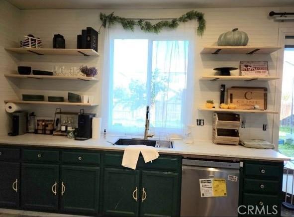 bar with stainless steel dishwasher and a sink