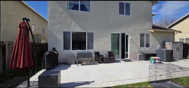 back of property featuring a patio area, fence, central AC unit, and stucco siding