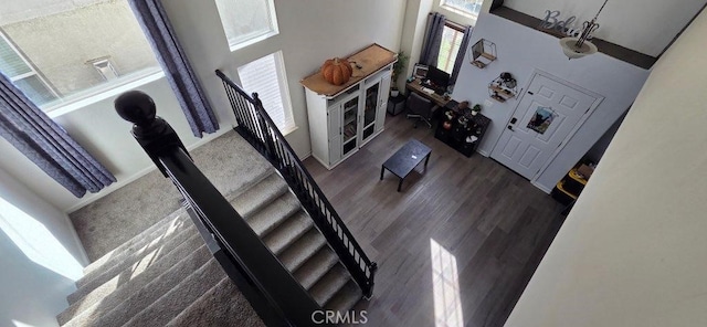 living room with stairway and wood finished floors