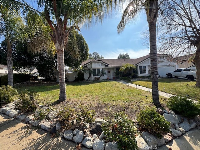 single story home with a garage and a front lawn