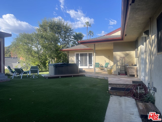 view of yard with a patio area and a hot tub