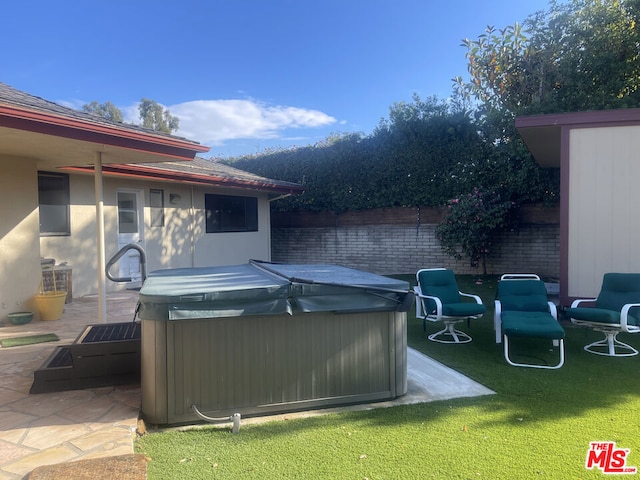 exterior space with a hot tub and a patio