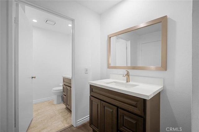 bathroom featuring vanity, tile patterned floors, and toilet