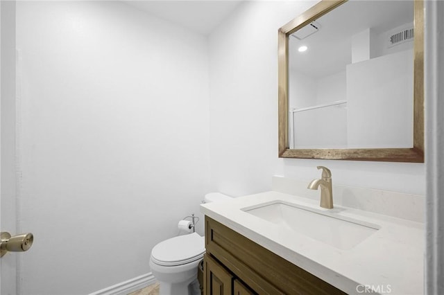 bathroom featuring vanity and toilet