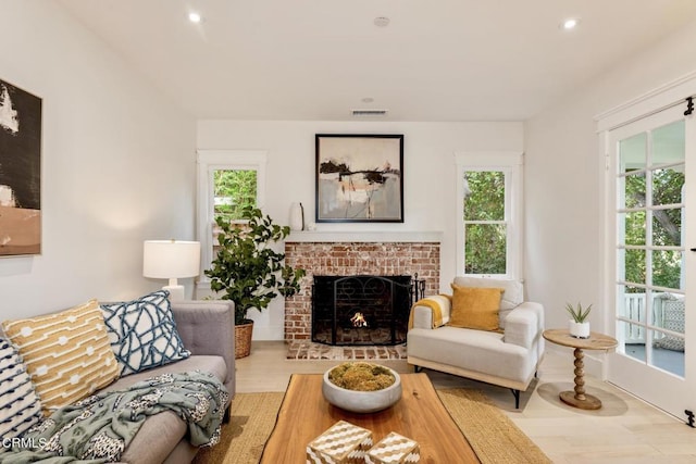 living room with a fireplace and light hardwood / wood-style flooring