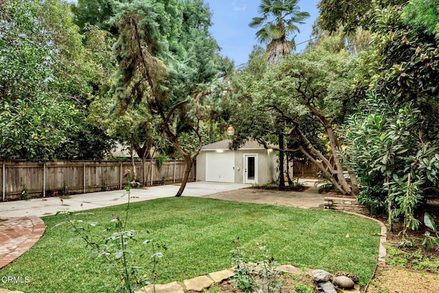 view of yard featuring an outbuilding and a patio