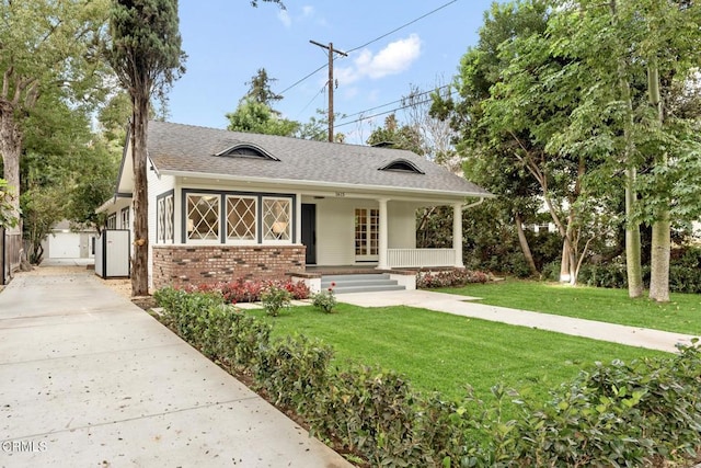 view of front of property with a porch and a front yard