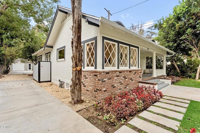 view of side of home with covered porch