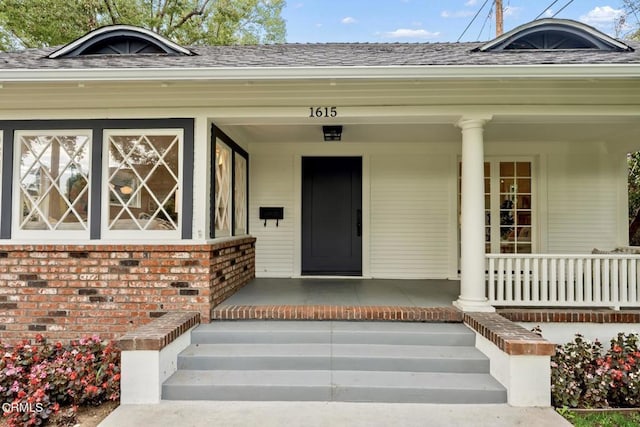 entrance to property with elevator and covered porch