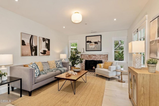 living room featuring a fireplace and light hardwood / wood-style flooring