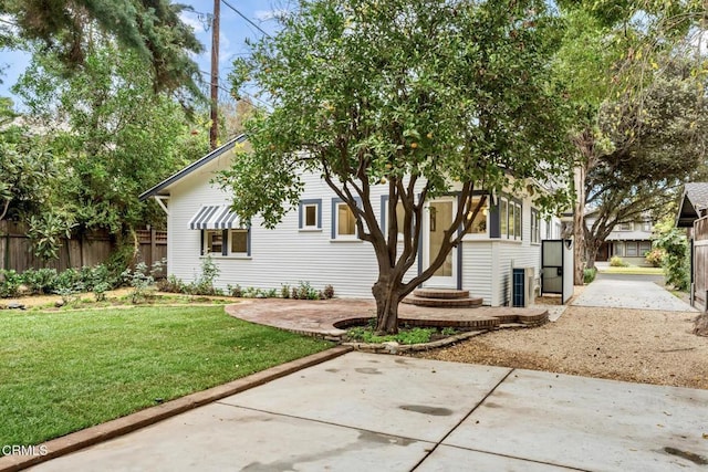 exterior space with a front lawn and a patio