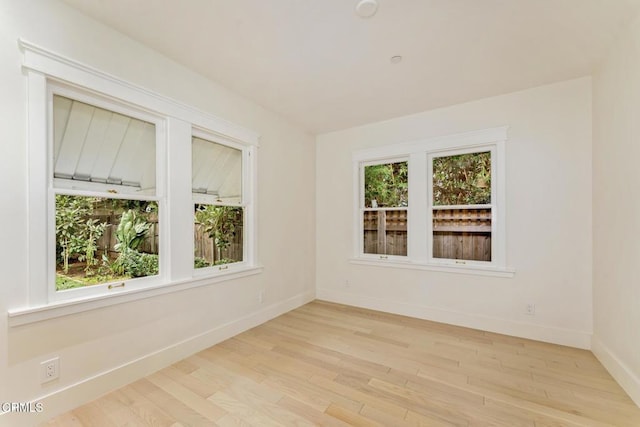 spare room with light hardwood / wood-style floors