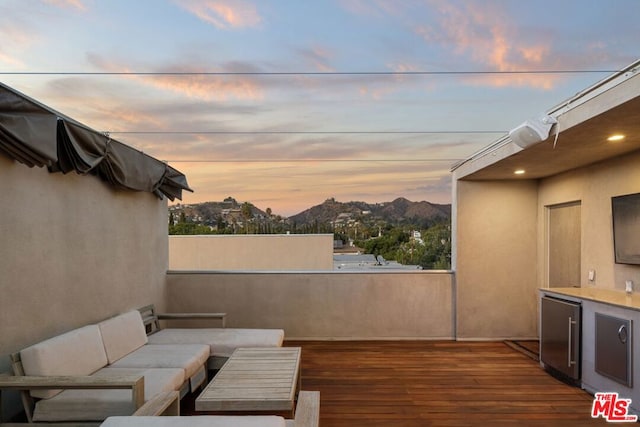 exterior space featuring outdoor lounge area and a deck with mountain view