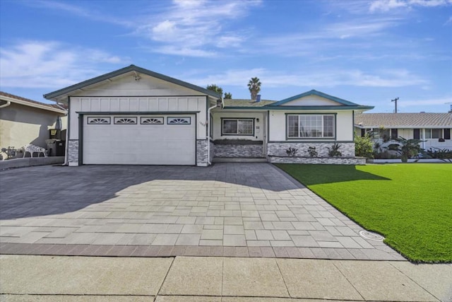 single story home with a garage and a front lawn