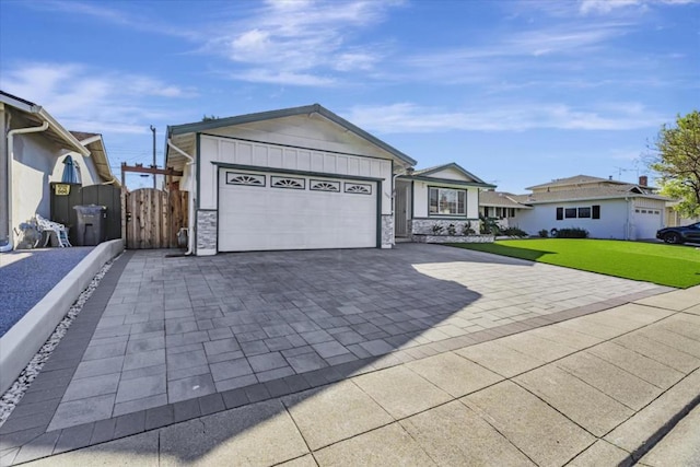 ranch-style home with a garage and a front lawn