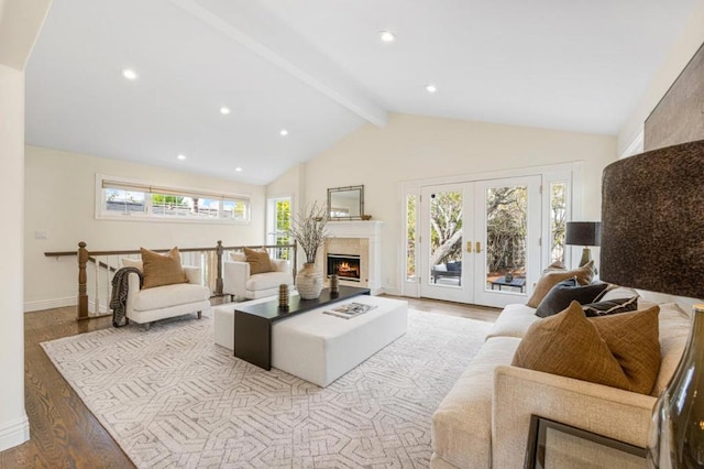 living room featuring vaulted ceiling with beams, light hardwood / wood-style floors, and french doors