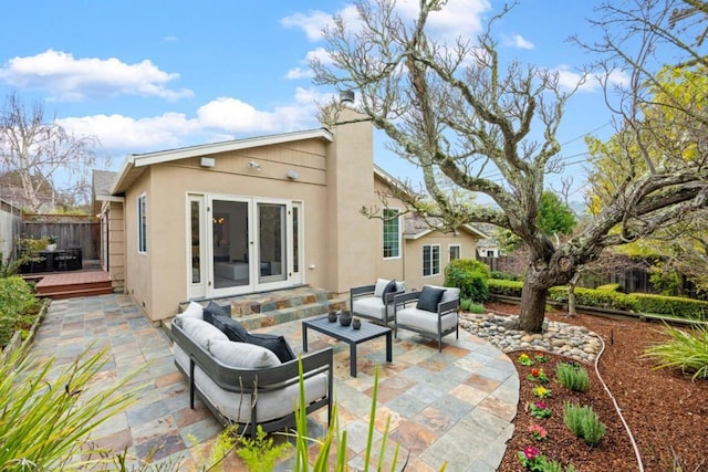 rear view of house featuring an outdoor living space, a patio, and a deck